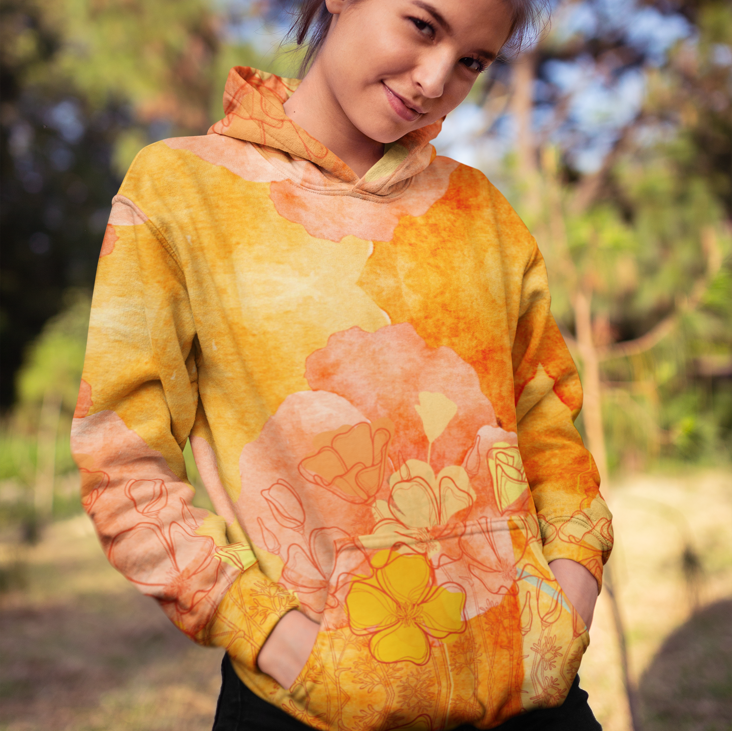 Surf, featuring a vibrant orange poppy design. Made from 95% recycled polyester and 5% spandex, this hoodie has a soft cotton-feel fabric on the outside and a brushed fleece interior for extra warmth. It features a relaxed fit, double-lined hood with design on both sides, and drawstrings for a customizable fit. Perfect for beach bonfires, casual outings, or cozy nights in, this stylish and sustainable hoodie is a must-have for any beach lover.