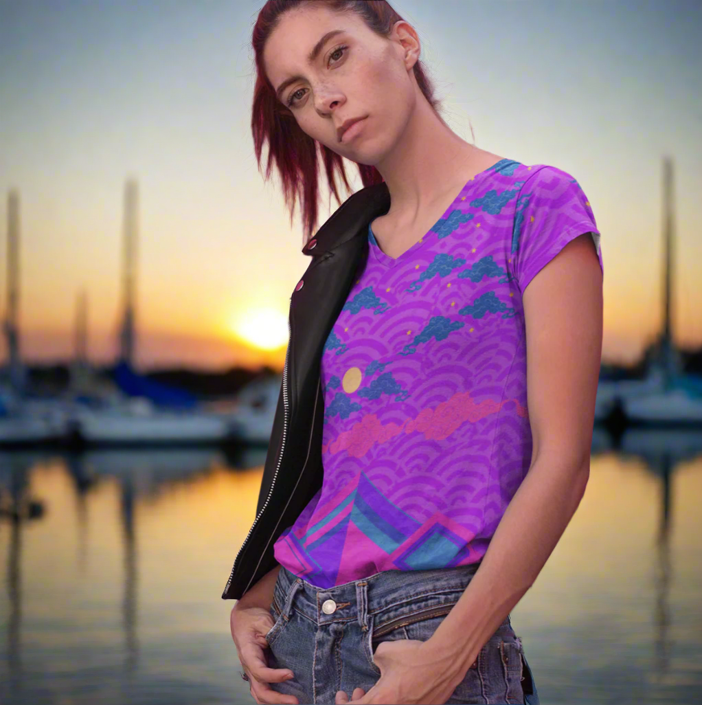 Lady wearing the Chameleon Surf Japan Sky Reflective Mountains Purple Women's T-shirt, featuring a vibrant blend of purples, pinks, and turquoise in a stunning reflective mountain design. This super smooth and comfortable T-shirt, crafted from cotton-touch polyester jersey, offers unmatched comfort and stays fresh after multiple washes. Perfect for any season, this stylish tee captures the essence of both summer and fall.
